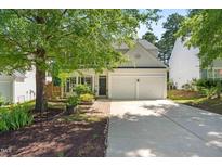 Charming home with a two-car garage, landscaped front yard, and a welcoming entrance at 410 Willingham Rd, Morrisville, NC 27560