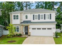 Charming two-story home with stone accents, a well-manicured lawn, and a two-car garage at 525 Kings Lake Way, Durham, NC 27703