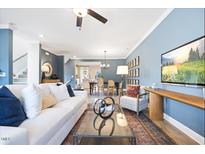 Bright living room with a white sofa, glass coffee table, and a stylish decor at 547 Forestville Rd, Wake Forest, NC 27587