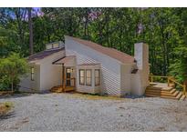 Charming exterior view of modern home with a wooden deck and a gravel driveway at 5709 Russell Rd, Durham, NC 27712