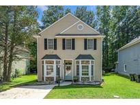 Charming two-story home featuring traditional architecture and a well-maintained front yard at 6008 River Lake Cir, Raleigh, NC 27604