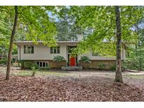 Traditional home featuring a well-maintained front yard with a red front door at 623 Totten Pl, Chapel Hill, NC 27514