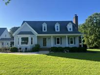 Charming Cape Cod home with well-manicured lawn and inviting front porch at 759 Wheeler Dr, Angier, NC 27501