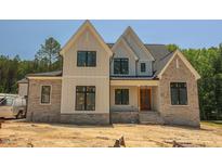 Beautiful two-story home featuring stone accents and a modern farmhouse design at 1112 Delilia Ln, Wake Forest, NC 27587