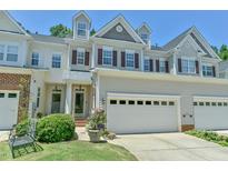 Charming townhome with two-car garage, manicured lawn, and classic architectural details at 119 Jones Creek Place Pl # 119, Chapel Hill, NC 27516