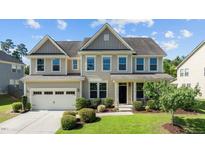 Charming two-story home featuring manicured landscaping and a welcoming front porch at 2120 Rainy Lake St, Wake Forest, NC 27587