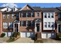 Charming brick townhome with black shutters, a one-car garage, and steps up to the front door at 2507 Princewood St, Raleigh, NC 27612