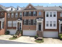 Charming brick townhomes with private garages and inviting front entrances at 2507 Princewood St, Raleigh, NC 27612