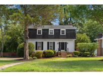 Charming two-story home features a landscaped yard and classic architectural details at 3317 Harden Rd, Raleigh, NC 27607