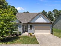 Charming single-Gathering home with a well-maintained lawn and a two-car garage with a concrete driveway at 35 Clubhouse Dr, Youngsville, NC 27596