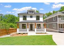Charming two-story home featuring a welcoming front porch and a well-manicured lawn at 3934 Old Chapel Hill Rd, Durham, NC 27707