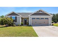 Charming single-story home with a well-manicured lawn and an attached two-car garage at 46 Bellini Dr, Angier, NC 27501