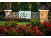 Community entrance with stone pillars, manicured landscaping, and 'Serenity' sign at 48 Firefly Ln, Fuquay Varina, NC 27526