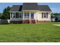 Charming single-story home with a well-manicured lawn, brick foundation and quaint front porch at 516 Yellow Berry, Wendell, NC 27591