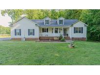 Charming home featuring a well-manicured lawn, white siding, inviting porch, and classic black shutters at 5307 Green Riley Rd, Rougemont, NC 27572