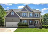 Charming two-story home with a beautifully landscaped front yard and welcoming front porch at 6332 Mountain Oaks Way, Wake Forest, NC 27587