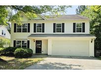 Charming two-story home with black shutters and a well-maintained front yard at 709 Woodgreen Dr, Durham, NC 27704