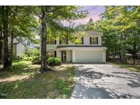 Charming two-story home with white siding, black shutters, and a two-car garage at 709 Woodgreen Dr, Durham, NC 27704