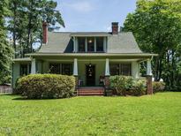 Charming home featuring a front porch with columns and a well-manicured lawn at 714 Spring Ln, Sanford, NC 27330