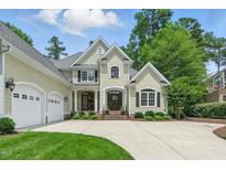 Charming two-story home with a three car garage, beautiful landscaping, and a well manicured lawn at 812 Bear Tree Crk, Chapel Hill, NC 27517