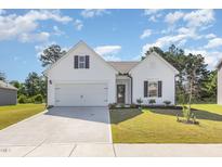 Charming one-story home with a manicured lawn and a two-car garage, offering classic curb appeal at 823 Biltmore Dr, Sanford, NC 27332