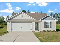 Charming single-story home featuring a two-car garage, well-maintained lawn, and welcoming curb appeal at 87 Royal Meadow Dr, Angier, NC 27501