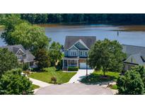 Inviting two-story home with a well-manicured lawn overlooking a beautiful lake at 9701 Corktree Ct, Wake Forest, NC 27587