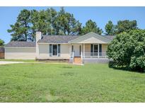 Charming home featuring a classic front porch and a well-maintained lawn at 111 Marshay Meadow Rd, Youngsville, NC 27596