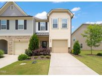 Charming townhome with a well-maintained lawn and attached one-car garage at 1137 Amber Shadow Dr, Durham, NC 27703