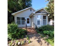 Charming single-story home with brick steps, manicured landscaping, and a welcoming front entrance at 1512 E Lane St, Raleigh, NC 27610