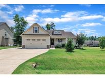 Charming one-story home featuring a well-manicured lawn and two-car attached garage at 22 Evie Dr, Smithfield, NC 27577