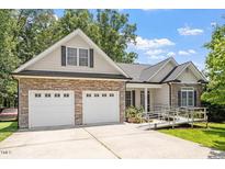 Charming home with stone accents, a two-car garage, and accessible ramp at 23 Northern Way Ct, Durham, NC 27712