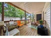 Relaxing back porch with wooden floors and comfortable seating for enjoying the outdoors at 2603 Stafford Ave # Apt C, Raleigh, NC 27607