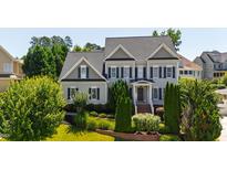 Inviting two-story home featuring well-manicured landscaping and classic architectural details at 307 Beacon Falls Ct, Cary, NC 27519