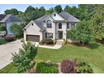 Charming two-story brick home with a well-manicured lawn and mature trees offering great curb appeal at 4219 Peachway Dr, Durham, NC 27705