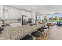 Modern kitchen features stainless steel appliances, granite countertops, and a breakfast bar with seating at 509 Kildaire Farm Rd # 101, Cary, NC 27511