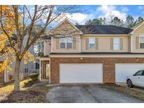 Charming townhouse with a brick facade and attached two-car garage in a well-maintained neighborhood at 513 Woodson Dr, Clayton, NC 27527