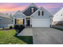 Charming single-Gathering home with a well-manicured lawn and attached two-car garage at 614 Marian Way, Sanford, NC 27330