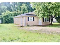 Charming single story home featuring tan siding, black shutters, and a well-maintained lawn at 621 Reservoir St, Durham, NC 27703