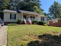 Charming single-story home with a well-maintained lawn and inviting front porch at 908 E Hudson Ave, Durham, NC 27704