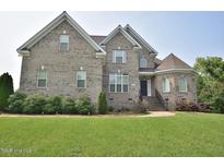 Charming two-story brick home featuring well-manicured landscaping and a welcoming entrance at 1126 Falling River Walk, Rocky Mount, NC 27804