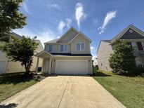 Charming two-story home featuring a spacious driveway and inviting front porch at 1618 Brownairs Ln, Raleigh, NC 27610
