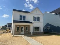 Charming two-story home with white siding, brick accents, and a welcoming front porch at 257 Marvel Dr # 135, Rolesville, NC 27571