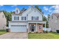 Charming two-story home with white siding, brick accents, and a well-manicured lawn at 3119 Guiding Light Rd, Raleigh, NC 27610