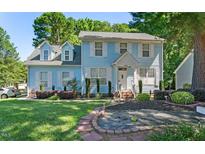 Charming two-story home with a well-manicured lawn and beautiful landscaping, great curb appeal at 3610 Long Ridge Rd, Durham, NC 27703