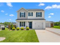 Charming two-story home featuring a well-manicured lawn and appealing curb appeal with blue shutters at 413 Hallie Long Ln, Burlington, NC 27217