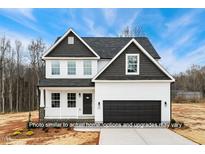 Charming two-story home with white siding, black trim, and a well-manicured lawn at 5428 Jaeger Dr # 45, Graham, NC 27253