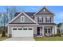 Beautiful two-story home with gray siding, black shutters, and a two-car garage at 65 Tennyson Dr, Garner, NC 27529