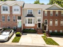 Charming townhouses feature brick facades, well-manicured landscaping, and inviting entrances at 6809 Middleboro Dr Dr, Raleigh, NC 27612