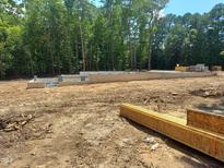 New home construction showing foundation with wood and concrete blocks ready for the next stage of construction at 8912 Thompson Mill Rd, Wake Forest, NC 27587